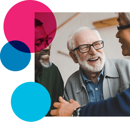 3 older male unpaid family carers of different ethnicity smiling and chatting